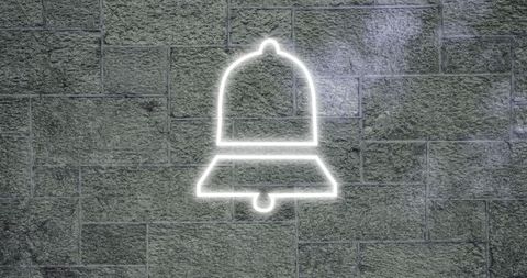 Neon bell conveys modern urban energy on stone wall