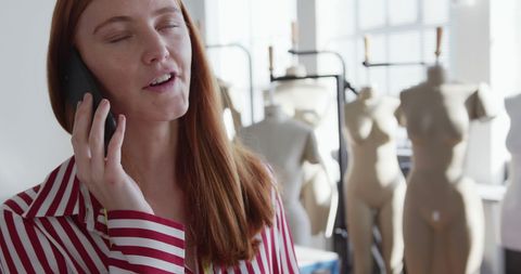 Fashion Designer Speaking on Smartphone in Studio