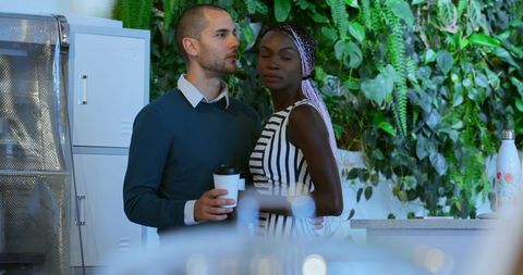 Diverse colleagues bonding in office break room