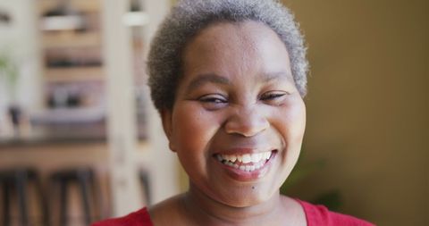 Smiling Woman Enjoying Warm and Festive Home Atmosphere