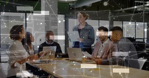 Collaborative Team Reviewing Project with Data Overlay in Modern Office