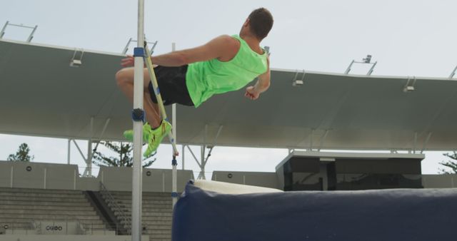 Male Athlete in Mid-Air During High Jump Competition - Download Free Stock Images Pikwizard.com