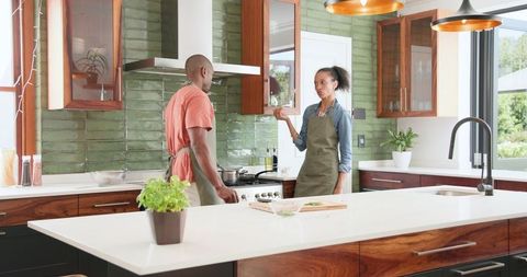 Couple Cooking Together in Modern Kitchen Sharing Conversation