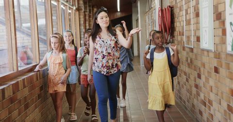 Female Teacher Walking with Young Diverse Students in School Hallway - Download Free Stock Images Pikwizard.com