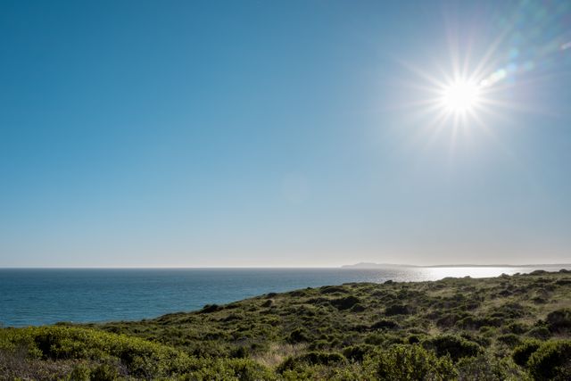 Bright Sun Over Coastal Landscape with Clear Blue Sky - Download Free Stock Photos Pikwizard.com