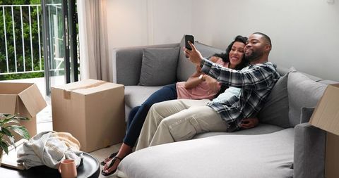 Happy Couple Taking Selfie After Moving into New Home