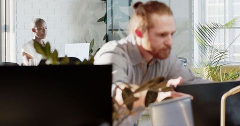 Colleagues Collaborating in Sunlit Modern Office Space