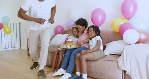 Joyful Family Celebrating Birthday with Cake and Balloons