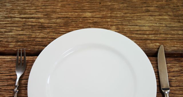 Empty White Plate with Fork and Knife on Wooden Table Background - Download Free Stock Images Pikwizard.com