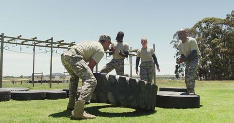 Determined soldiers in strength-training at obstacle course