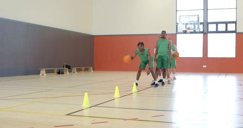 Indoor basketball drill dribbling through cones building agility coordination teamwork