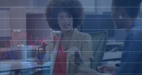 Business Professionals Analyzing Financial Data with Overlaid Graphs