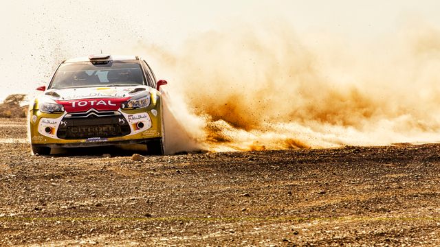 Racing Car in High-Speed Drift on Dirt Track Kicking up Dust - Download Free Stock Photos Pikwizard.com