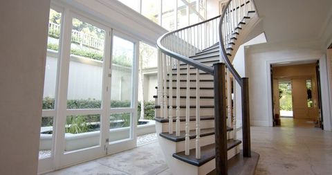 Elegant Spiral Staircase in Sunlit Luxury Interior