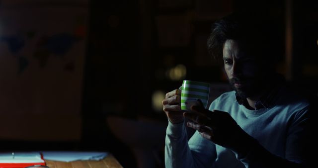 Man Enjoying Late Night Coffee in a Dimly Lit Room - Download Free Stock Images Pikwizard.com