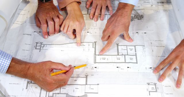 Hands Collaborating on Architectural Blueprint Design - Download Free Stock Images Pikwizard.com