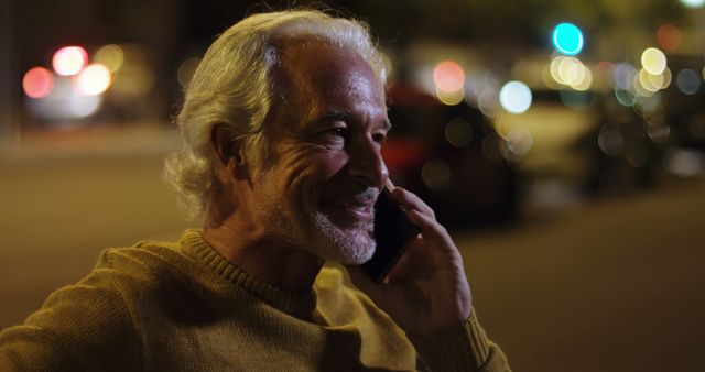 Senior man having phone conversation at night city lights background - Download Free Stock Images Pikwizard.com