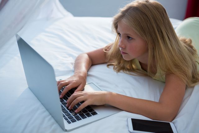 Young Girl Using Laptop on Bed at Home - Download Free Stock Photos Pikwizard.com