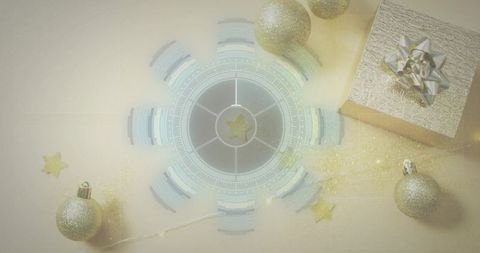 Glowing circular tech overlay with silver gift and gold baubles on pale beige tabletop