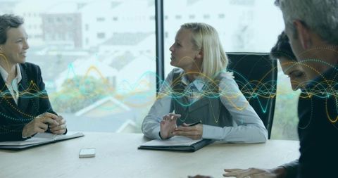 Professionals Collaborating Over Data in Modern Conference Room