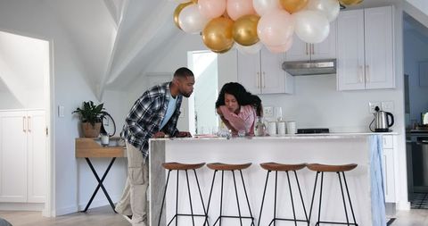 Couple Cleaning Up After Anniversary Celebration in Modern Kitchen