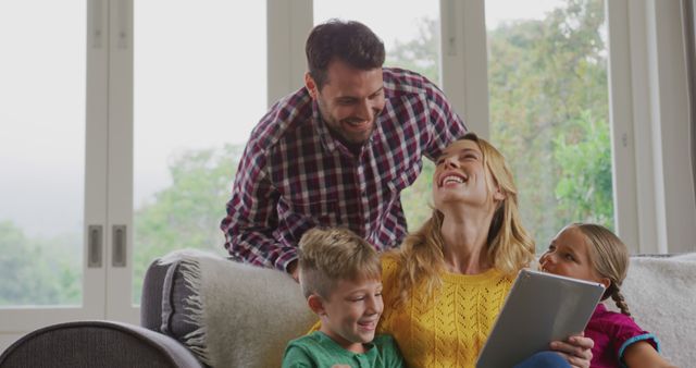 Happy Family Enjoying Leisure Time at Home with Digital Tablet - Download Free Stock Images Pikwizard.com