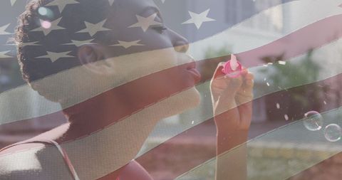 Young Woman Blowing Bubbles with Patriotic American Flag Overlay