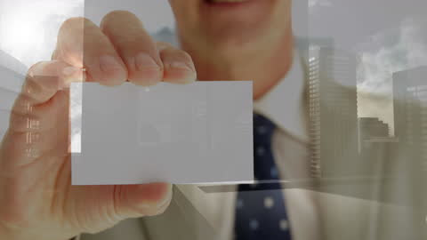 Businessman Displaying Blank Business Card With Cityscape Overlay