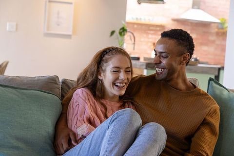 Happy couple enjoying relaxed moment on sofa at home