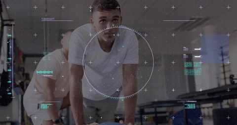 Man balancing on stability ball during partner workout in gym with futuristic hud