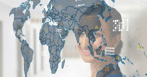 Smiling indian executive viewing transparent world map with data overlays in office