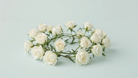White rose wreath on light mint background
