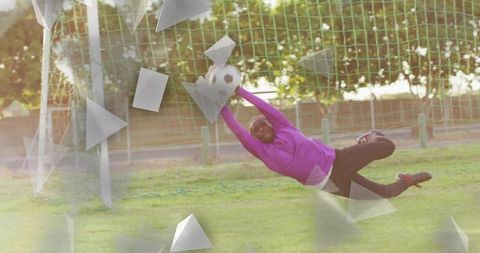 Athletic Female Goalkeeper Diving to Save Soccer Ball