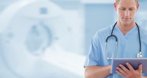 Caucasian Male Doctor Using Tablet in Modern Hospital