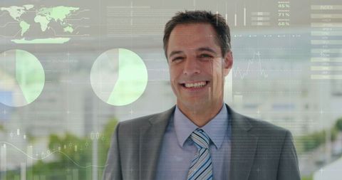 Executive smiling and presenting digital business charts in modern glass lobby