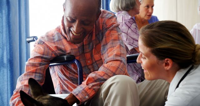 Senior Man in Wheelchair Enjoying Therapy Dog with Nurse Assistance - Download Free Stock Images Pikwizard.com