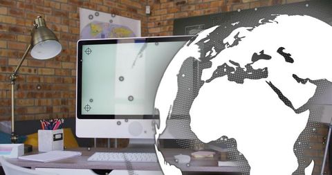Modern workspace featuring all-in-one desktop with globe overlay in warm brick office