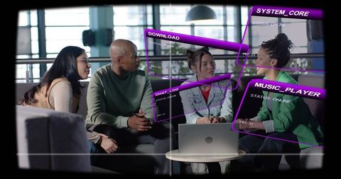 Team collaborating around laptop with futuristic purple holographic interface