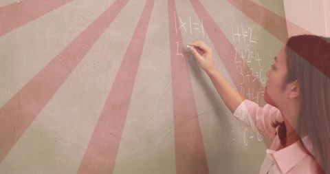 Teacher writing math equations on sunburst mural wall with chalk, pastel classroom vibe