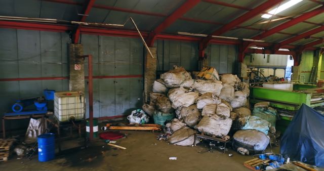 Piles of construction waste and debris in an industrial warehouse. Useful for illustrating industrial settings, waste management practices, environmental concerns, recycling projects, and repair or cleanup scenarios.