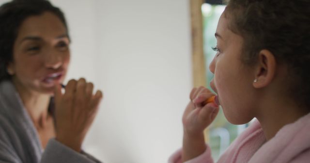 Happy Biracial Mother and Daughter Brushing Teeth Together in Bathroom - Download Free Stock Images Pikwizard.com