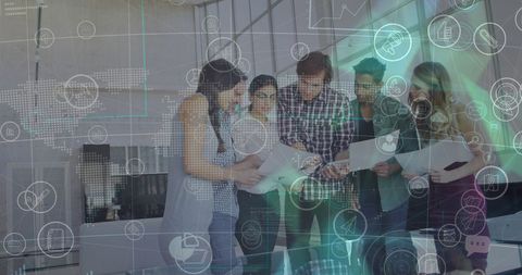 Diverse team collaborating in tech-enhanced office environment