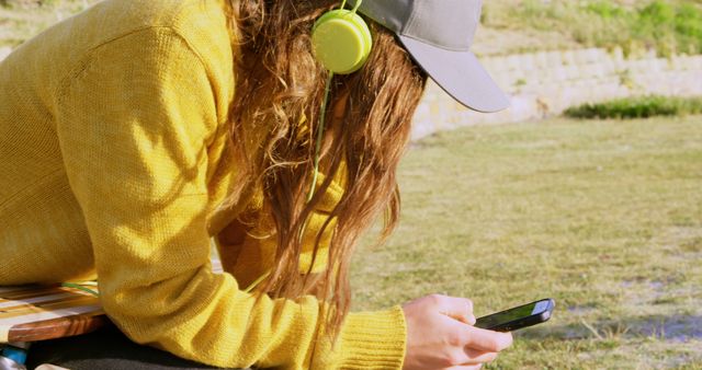 Young Woman Listening to Music on Smartphone in Park - Download Free Stock Images Pikwizard.com