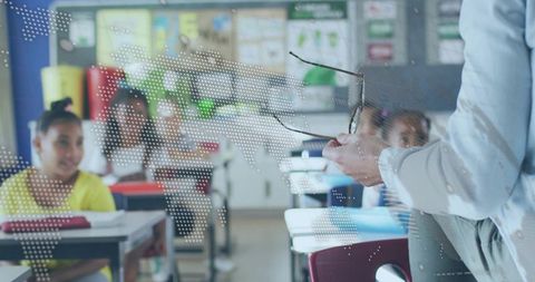 Teacher interacting with engaged students in modern classroom