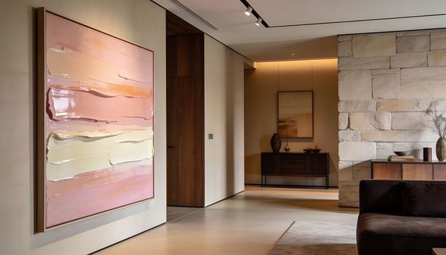 Soft pastel abstract wall art in modern foyer with stone feature and minimalist decor