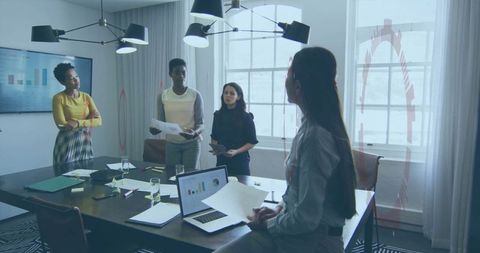 Business Meeting with Diverse Team Reviewing Data and Charts