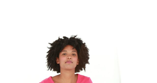 Confident Young Woman with Curly Hair Posing Against White Background - Download Free Stock Images Pikwizard.com