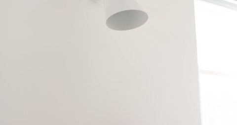Minimalistic white lamp in soft off-white interior