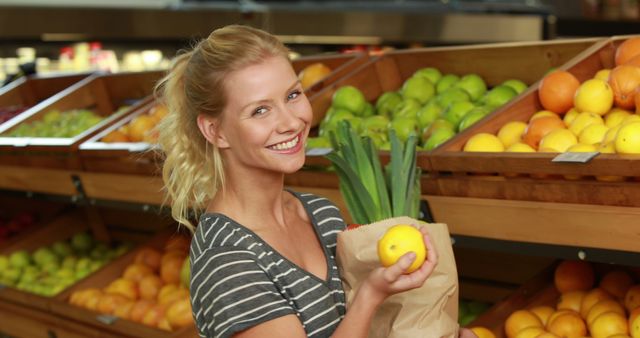 Smiling Woman Holding Vegetables and Fruit in Grocery Store - Download Free Stock Images Pikwizard.com