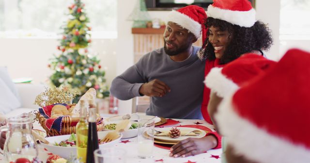 Family Celebrating Christmas Dinner in Santa Hats - Download Free Stock Images Pikwizard.com